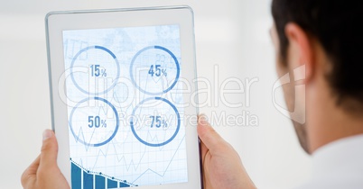 Man looking at graph chart on digital tablet