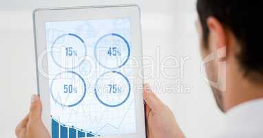 Man looking at graph chart on digital tablet