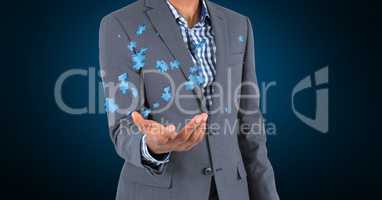 Digital composite image of businessman holding jigsaw puzzle pieces