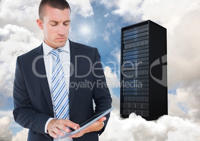 Digital composite image of businessman using digital tablet against server tower