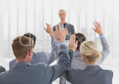 Businesspeople raising hands in meeting