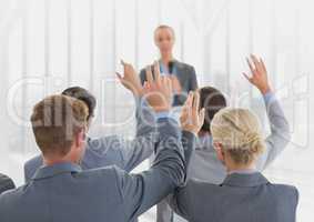 Businesspeople raising hands in meeting