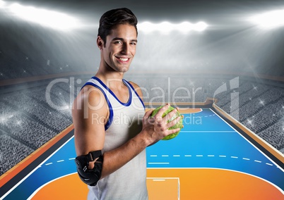Athlete holding handball against stadium in background