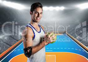 Athlete holding handball against stadium in background