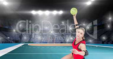 Athlete playing handball against stadium in background