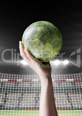 Athlete throwing handball against stadium in background