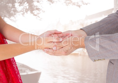 Couple holding hands against city in background