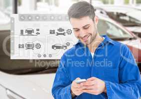 Happy automobile mechanic using mobile phone