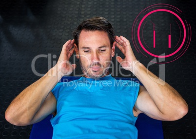 Fit man performing crunches exercise in gym against fitness interface in background