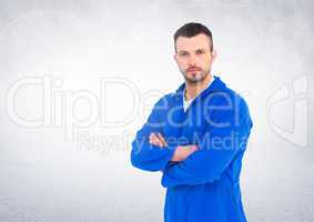 Confident automobile mechanic standing with arms crossed against white background