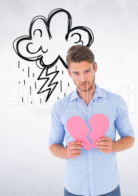 Depressed man holding broken heart against white background
