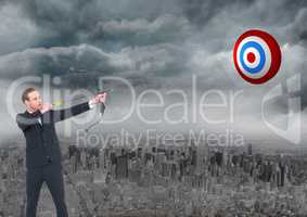Businessman holding bow and arrow while aiming at the target board
