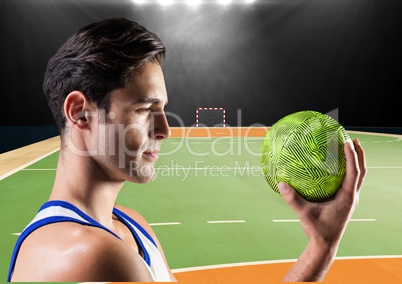 Focused player holding a handball in stadium