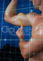 Muscular man measuring his biceps with tape