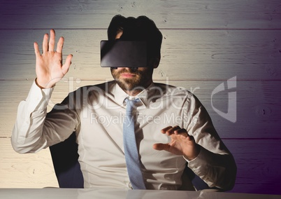 Businessman using virtual reality headset at desk