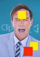 Frustrated businessman with sticky notes on him against blue background