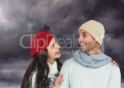 Happy couple wearing warm clothes and looking at each other