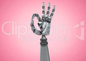 Robot hand showing ok sign against pink background