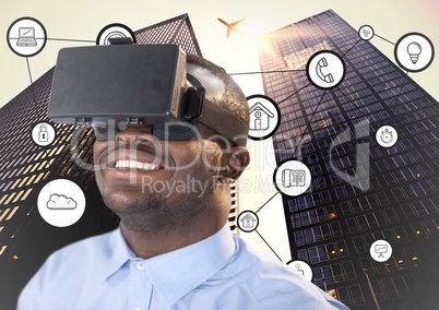Man using virtual reality headset with connecting icons and skyscrapers in background