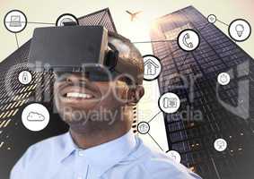 Man using virtual reality headset with connecting icons and skyscrapers in background