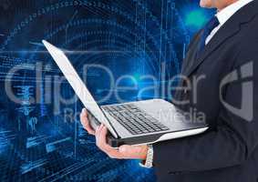 Businessman holding laptop with binary codes in background