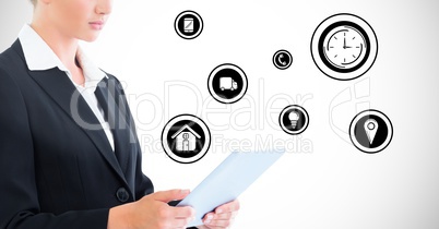 Businesswoman using digital tablet against application icons in background