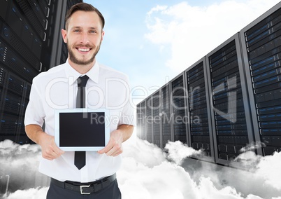 Man holding digital tablet against data center in background