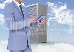 Businessman using digital tablet against database server system in sky