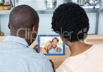 Couple having video call with friends on digital tablet