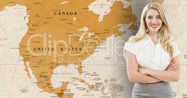 Businesswoman standing with arms crossed against world map in background