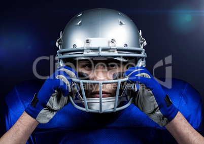 American football player adjusting his helmet