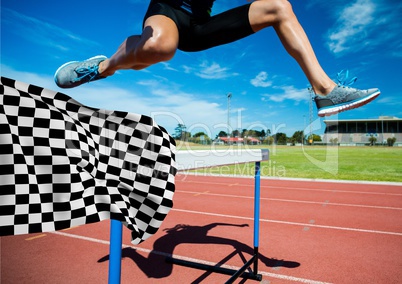 Athlete jumping over hurdles at the finish line