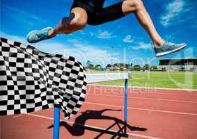 Athlete jumping over hurdles at the finish line