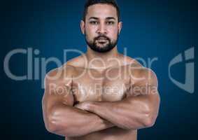 FitnessMuscular man standing with arms crossed against blue background
