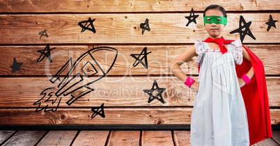 Portrait of girl wearing superhero costume standing with hands on hips
