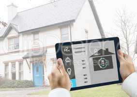 Man holding a digital tablet with home security concept