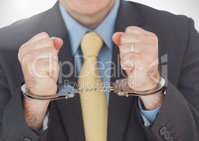 Businessman wearing handcuffs