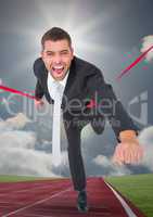 Businessman crossing finish line during race