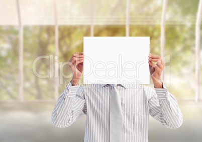 Businessman holding a blank placard in front of his face