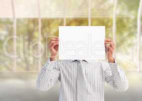 Businessman holding a blank placard in front of his face