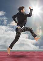 Businessman running on racing track