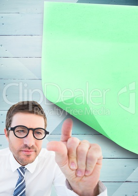 Businessman pointing at sticky note on wooden background