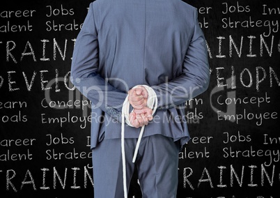 Rear view of businessman with his hands tied with rope