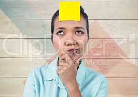 Frustrated woman with sticky note stuck on her head against wooden background