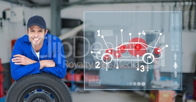 Mechanic leaning over tire against car mechanics in background