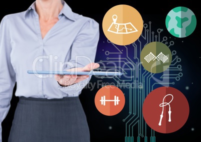 Businesswoman holding digital tablet agaist application icons in background