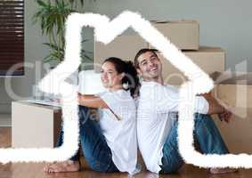 Couple sitting in living room against house outline in background