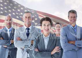 Group of confident businesspeople standing against American flag
