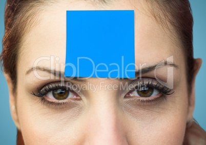 Portrait of woman with blank sticky note on forehead