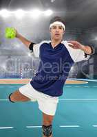 Male handball player throwing ball at handball court